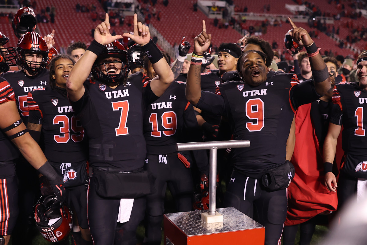 Utah Utes quarterback Cameron Rising (7) and running back Tavion Thomas (9) react to a win against the Stanford Cardinal at Rice-Eccles Stadium.